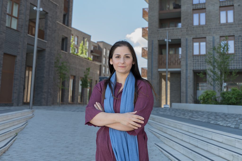 Nesil Caliskan, Member of Parliament for Barking, standing in front of new developments in Barking.