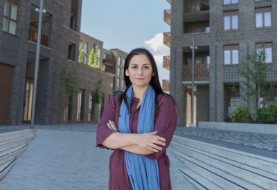 Nesil Caliskan, Member of Parliament for Barking, standing in front of new developments in Barking.